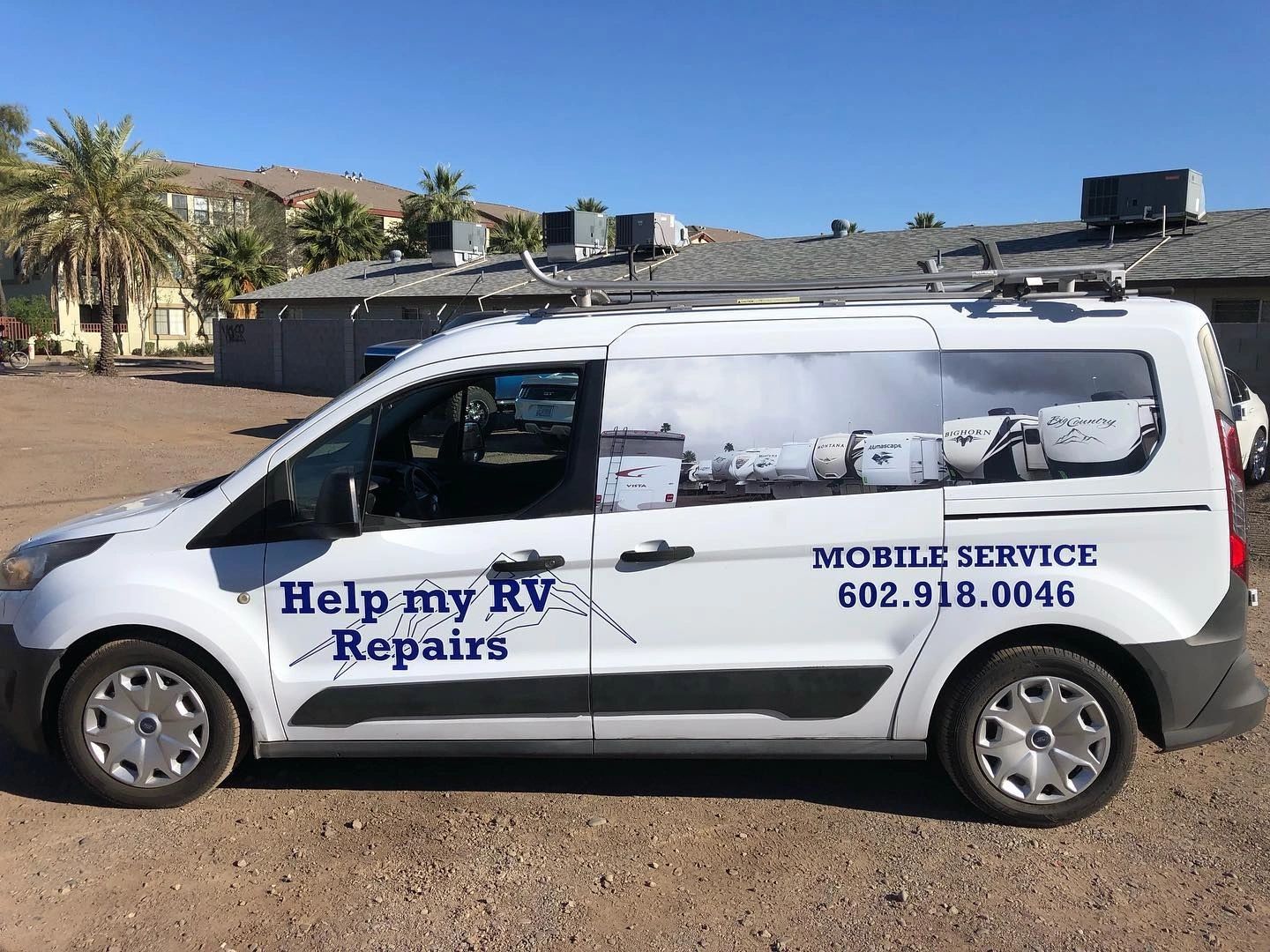 The Help My RV Repairs service van in profile, lettered Mobile Service 602.918.0046, parked on desert ground with palms behind.